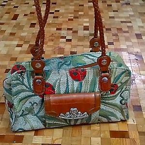 Lady bug and leather strap.  M.C. PURSE